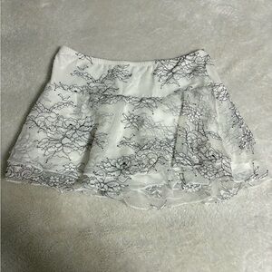 Chic White Lace Mini Skirt with Black Floral Design